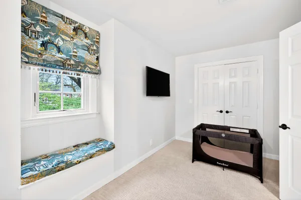 a room with a bed and a flat screen tv
