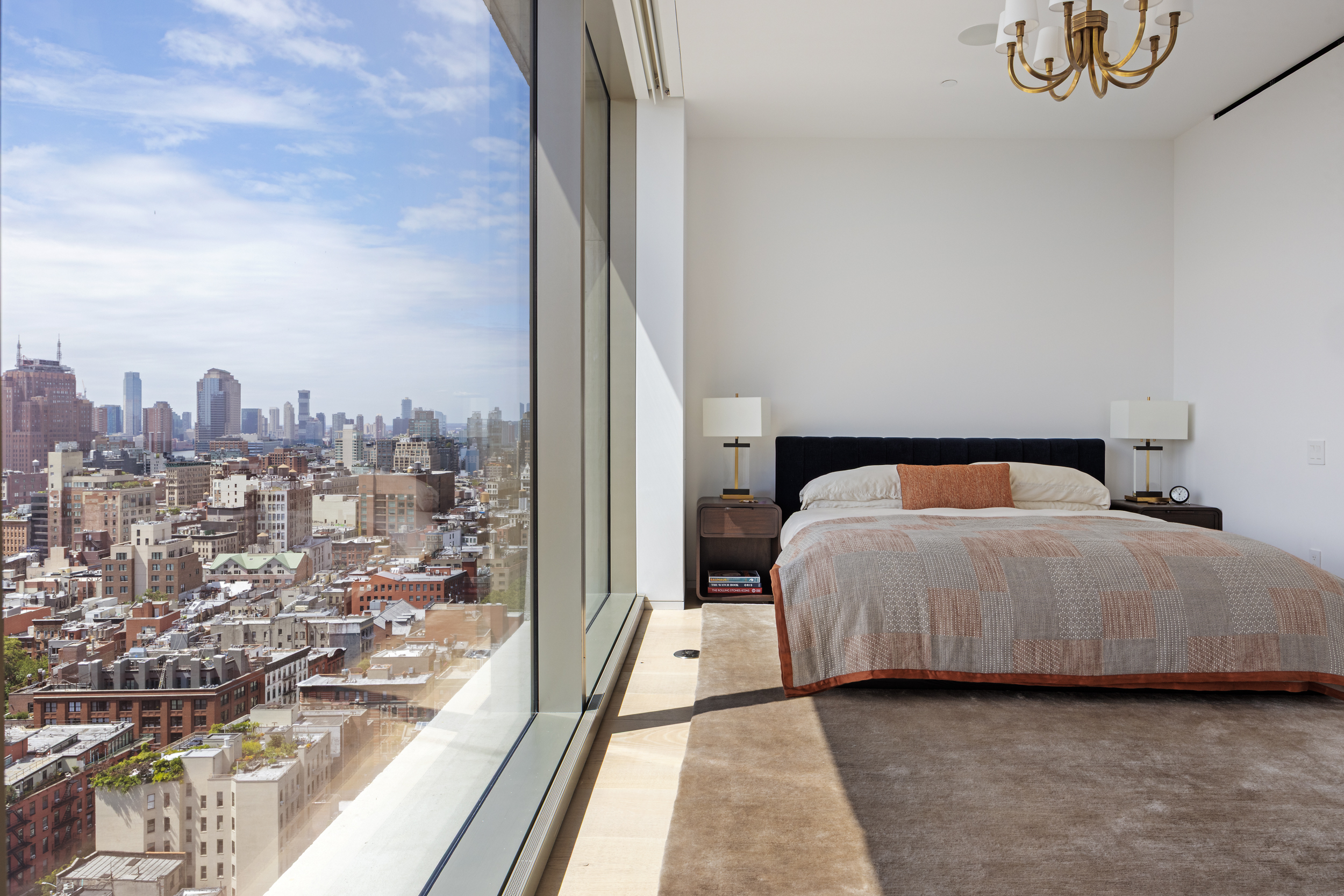 215 Chrystie Street, Unit 29W Manhattan, NY 10002 - Photo 16 of 24 a bedroom with a bed and a night stand