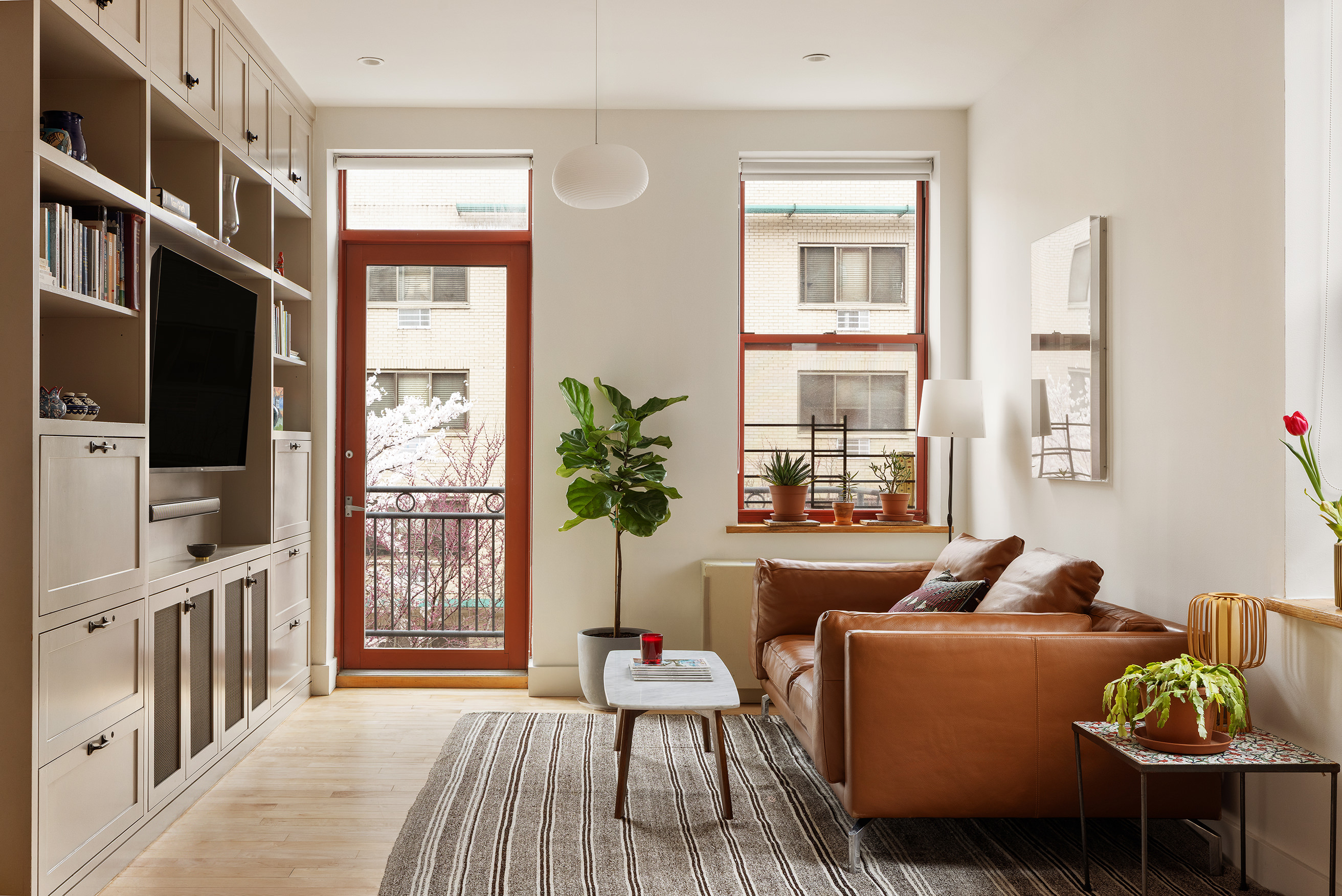 60 Tiffany Place, Unit 3G Brooklyn, NY 11231 - Photo 1 of 10 a living room with furniture a flat screen tv and a window