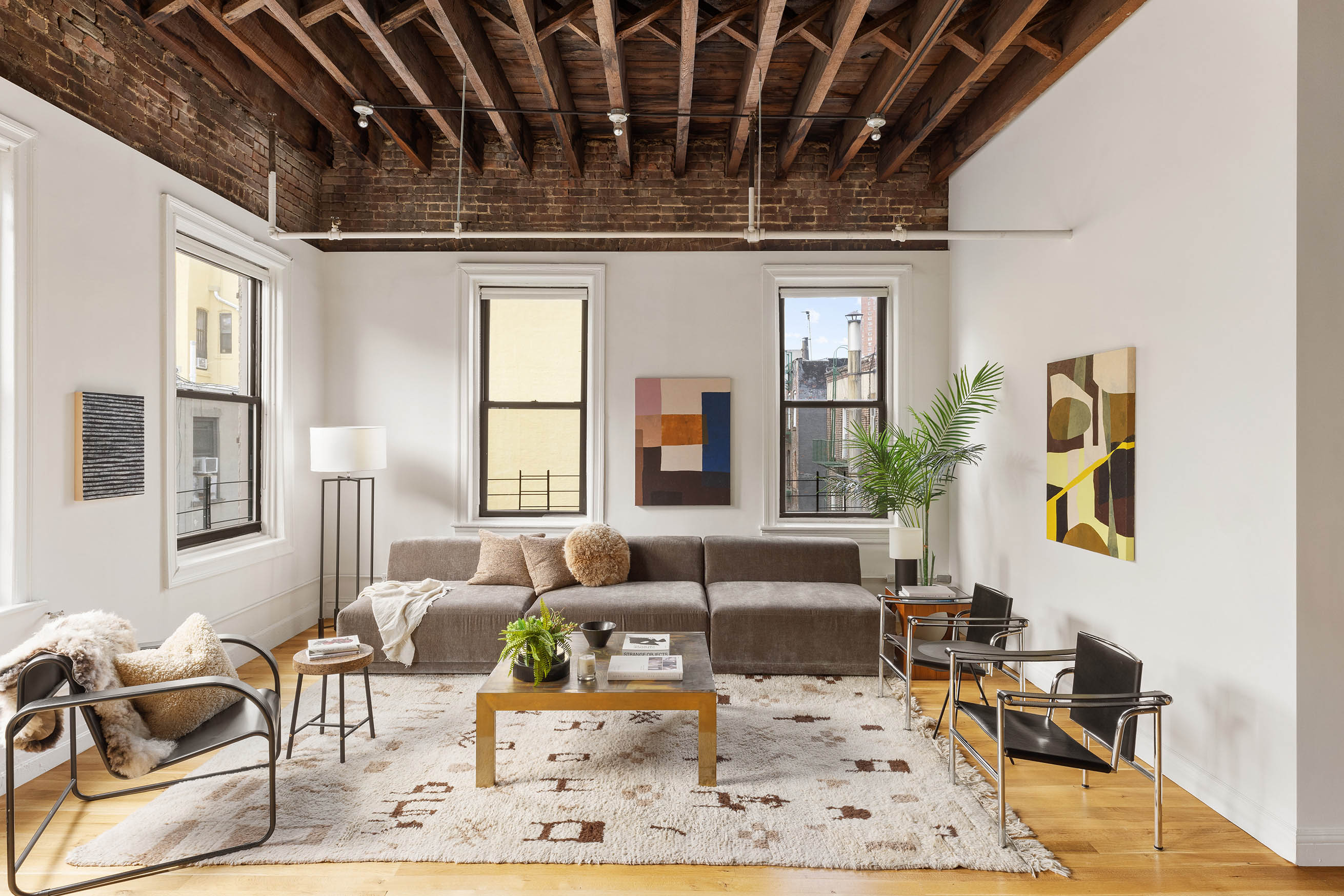 84 Forsyth Street, Unit 5R Manhattan, NY 10002 - Photo 4 of 14 a living room with furniture and painting on the wall