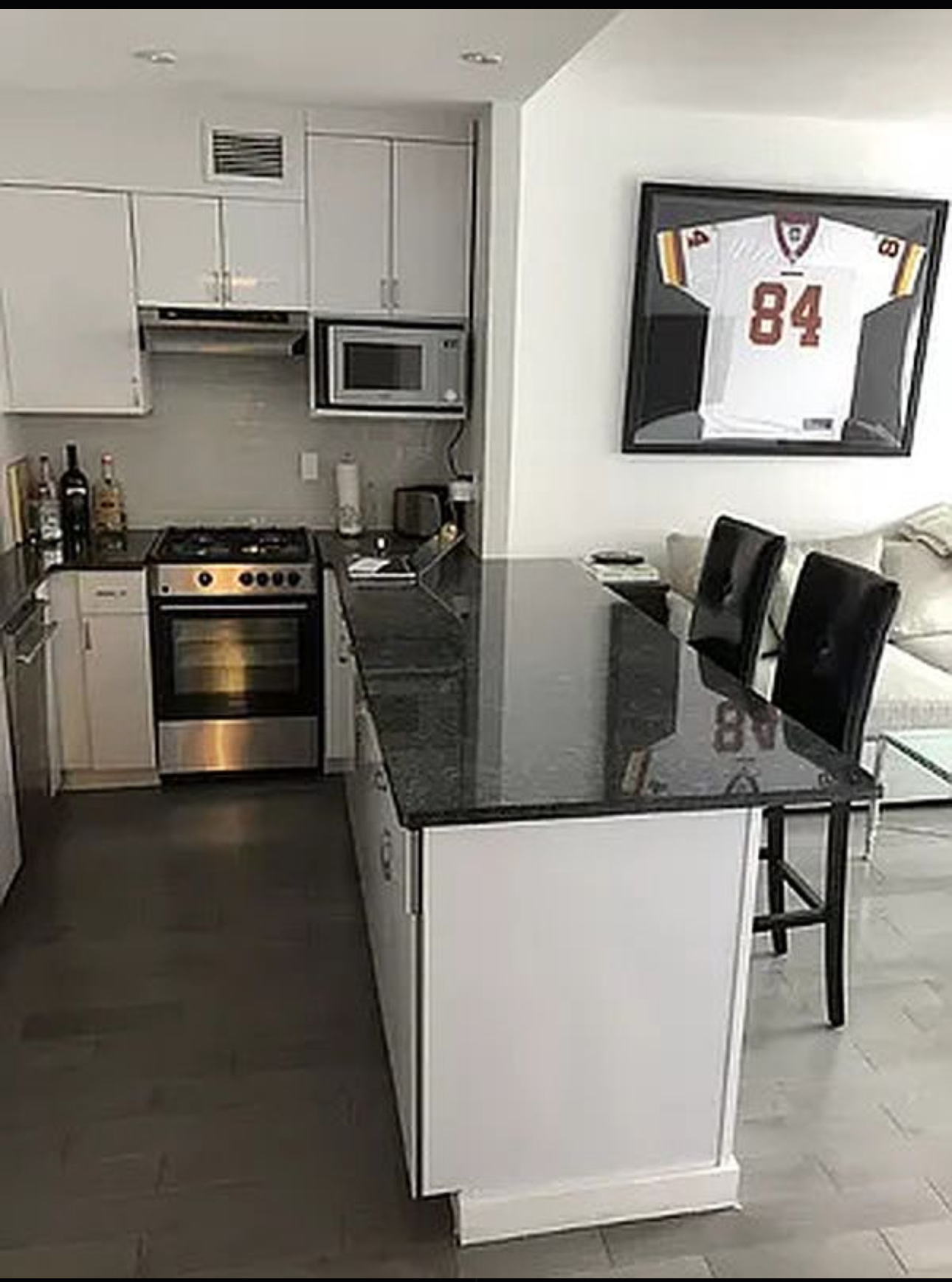 400 East 14th Street, Unit 4C Manhattan, NY 10009 - Photo 4 of 7 a kitchen with stainless steel appliances and stove top oven