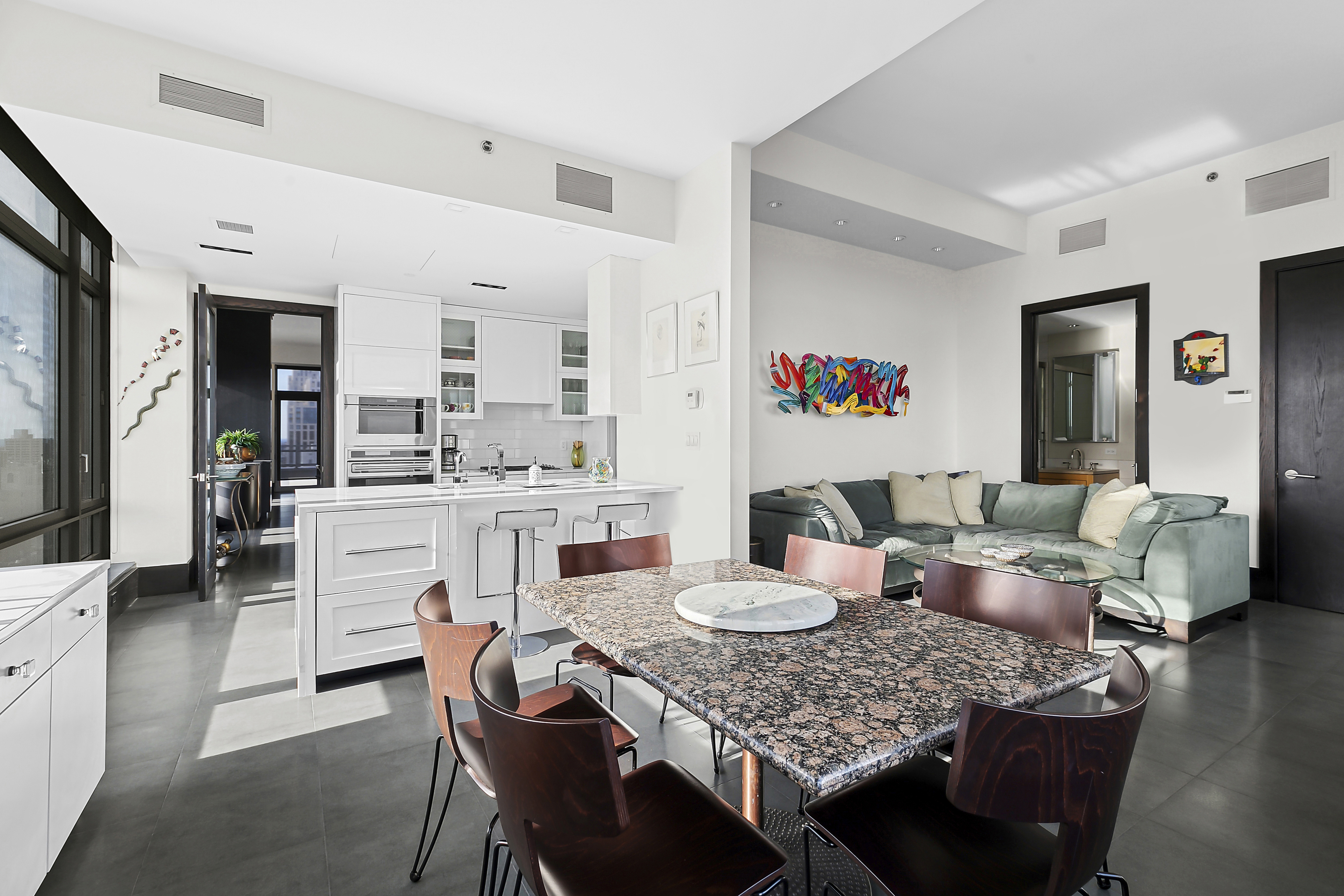 450 East 83rd Street, Unit PH1B Manhattan, NY 10028 - Photo 5 of 15 a living room with furniture and view of kitchen