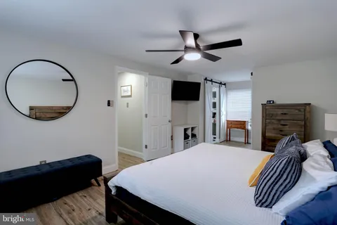 a bedroom with a bed and a ceiling fan
