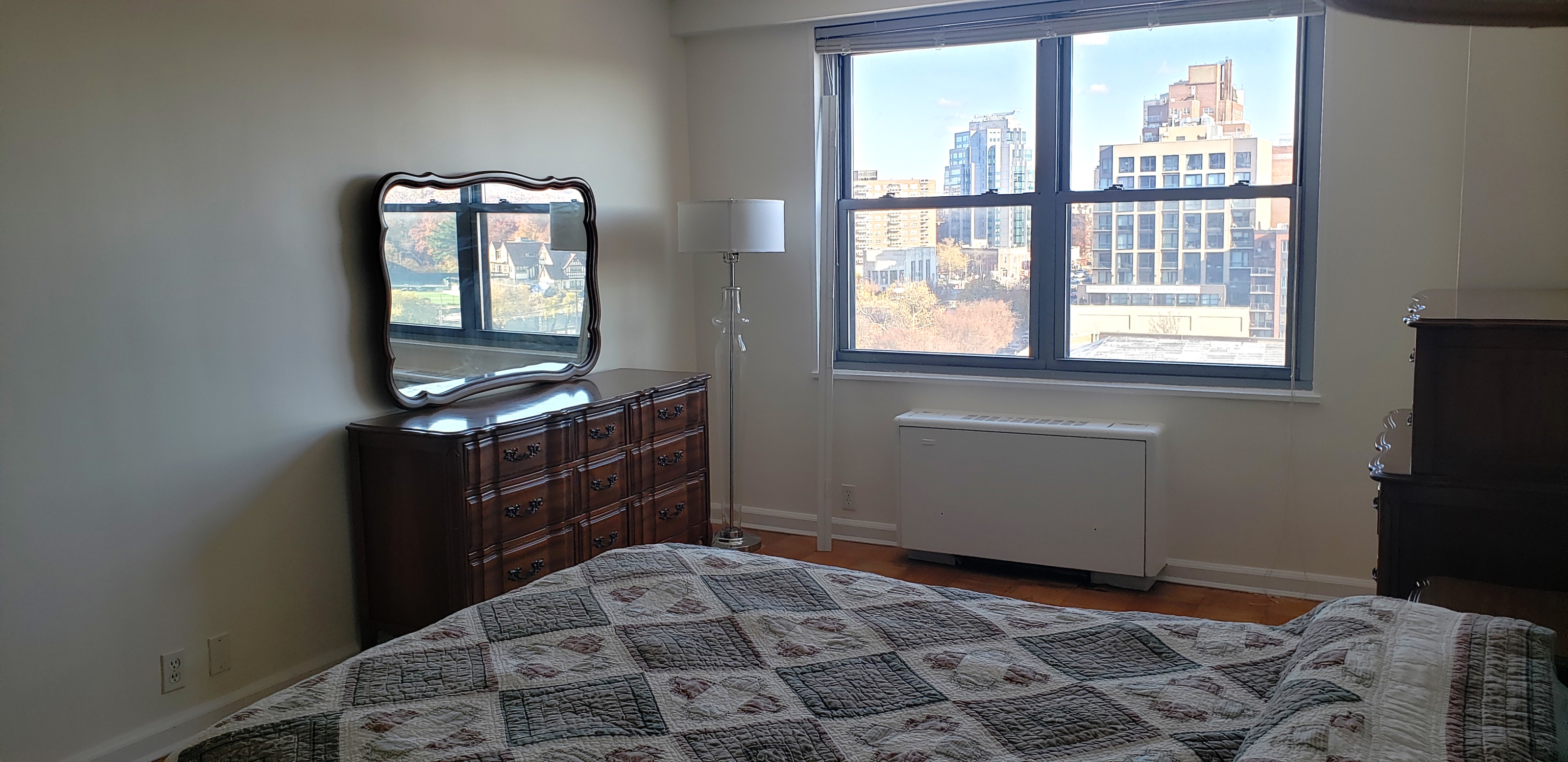 70-25 Yellowstone Boulevard, Unit 11D Queens, NY 11375 - Photo 10 of 25 a bedroom with a bed and a window