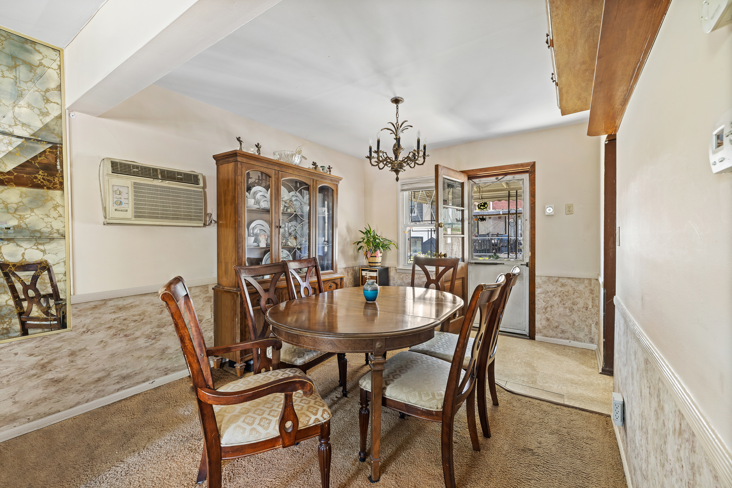 14-28 140th Street Queens, NY 11357 - Photo 5 of 14 a view of a dining room with furniture and chandelier