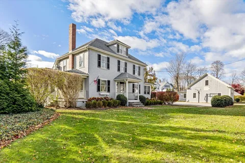 a view of house with yard and green space