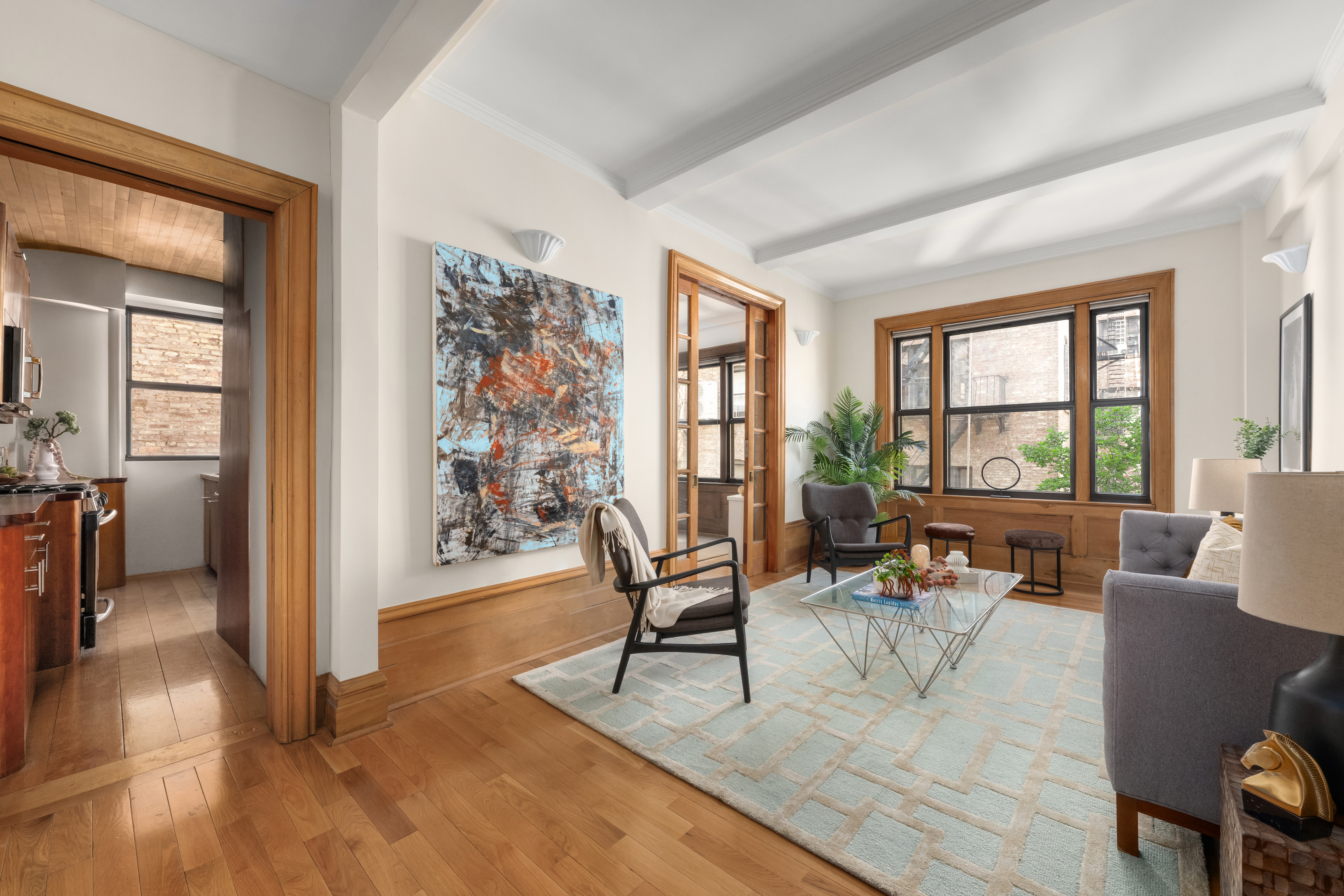 35 West 82nd Street, Unit 4C Manhattan, NY 10024 - Photo 2 of 11 a living room with furniture and a large window