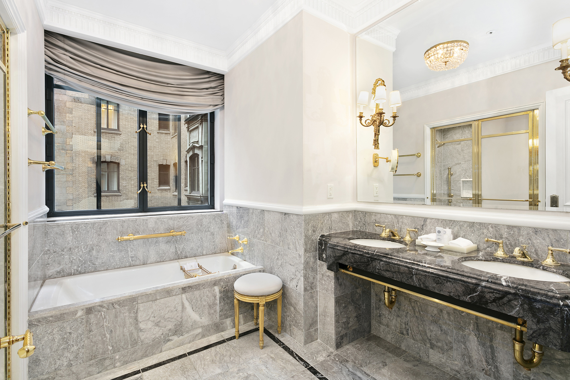 2 East 55th Street, Unit 1116 Manhattan, NY 10022 - Photo 3 of 14 a bathroom with a granite countertop sink and a large mirror