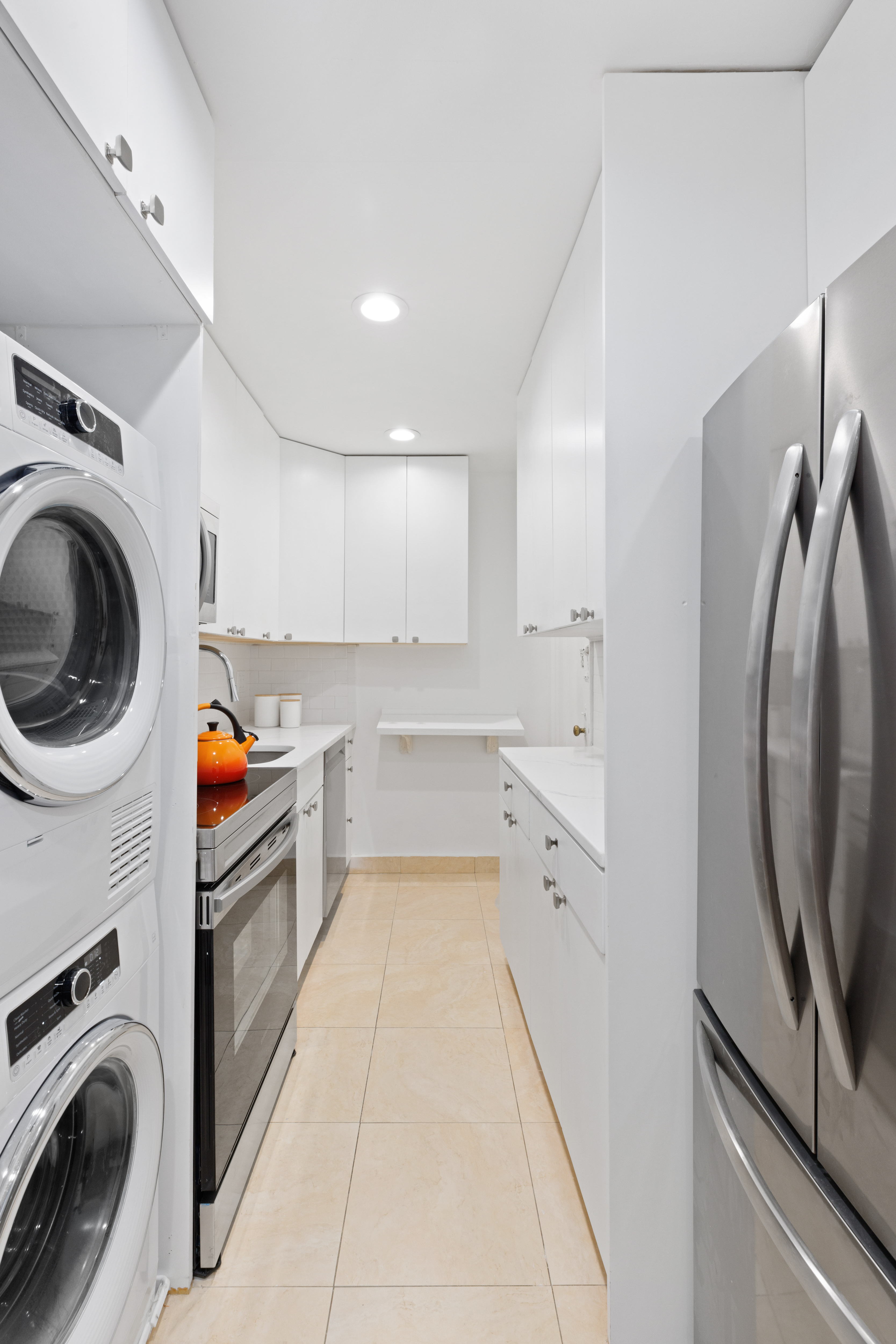 175 West 93rd Street, Unit 3D Manhattan, NY 10025 - Photo 4 of 10 a view of a kitchen with fridge and washer