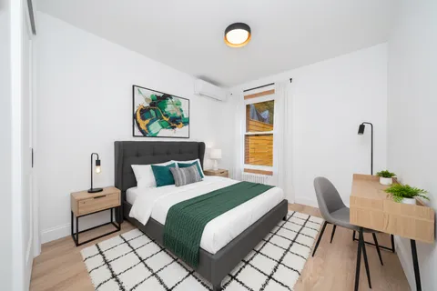 a bedroom with a bed and a chair