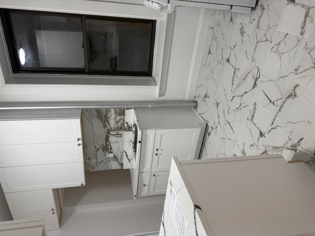 552 West 141st Street, Unit 1A Manhattan, NY 10031 - Photo 1 of 4 a kitchen with granite countertop white cabinets and white appliances
