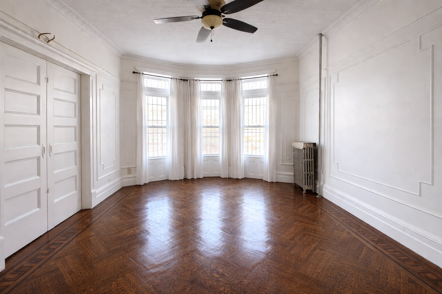 1100 Lincoln Place, Unit 1 Brooklyn, NY 11213 - Photo 1 of 8 a view of an empty room with a window and wooden floor