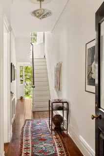 a view of a hallway with furniture and a window