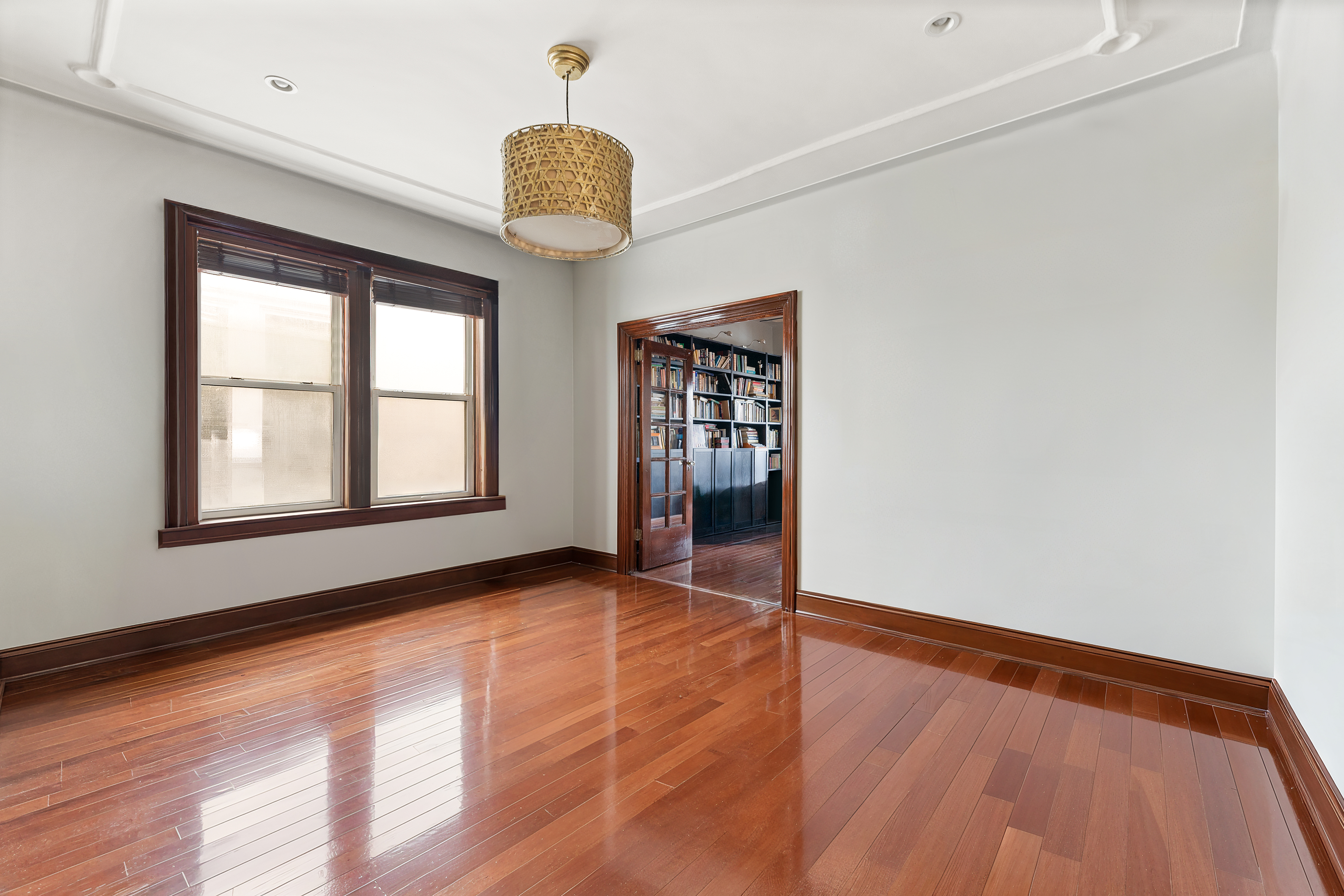 742 44th Street Brooklyn, NY 11220 - Photo 4 of 23 a view of an empty room with window and wooden floor