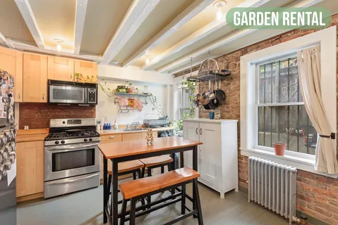 a kitchen with a stove a sink and a microwave