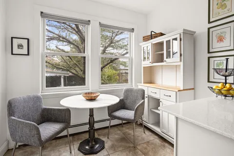 a dining room with furniture and window