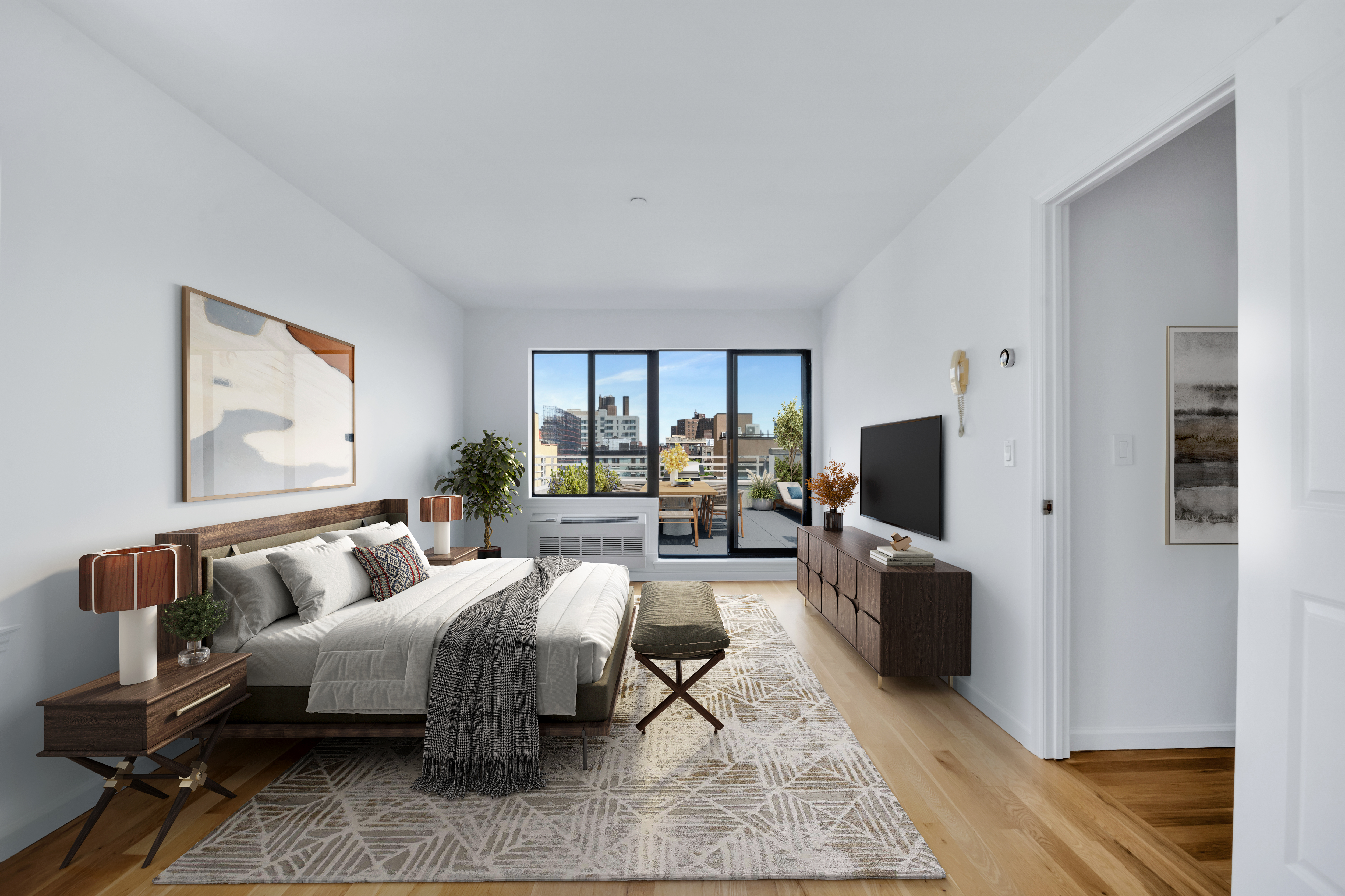 416 East 117th Street, Unit PH6 Manhattan, NY 10035 - Photo 8 of 18 a bedroom with furniture and a flat screen tv