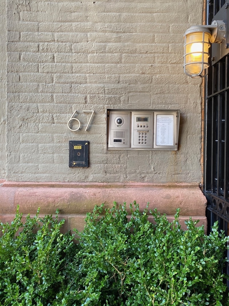 67 Hudson Street, Unit 4C Manhattan, NY 10013 - Photo 8 of 9 a front view of a house with lots of green space