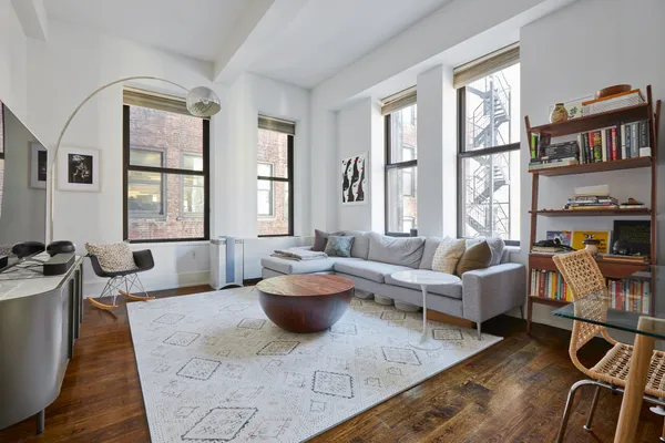 a living room with furniture fireplace and large window