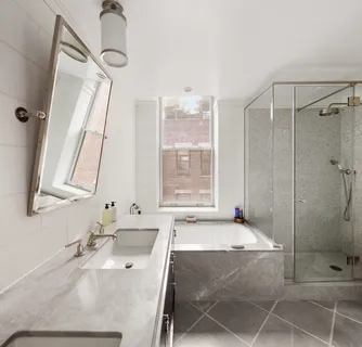 a spacious bedroom with a bed and a dresser