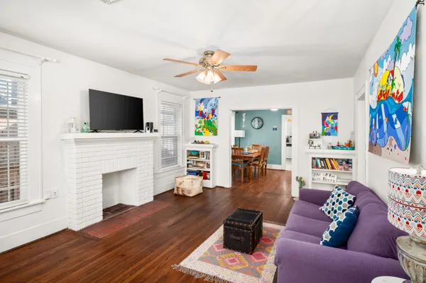 a living room with furniture fireplace and flat screen tv
