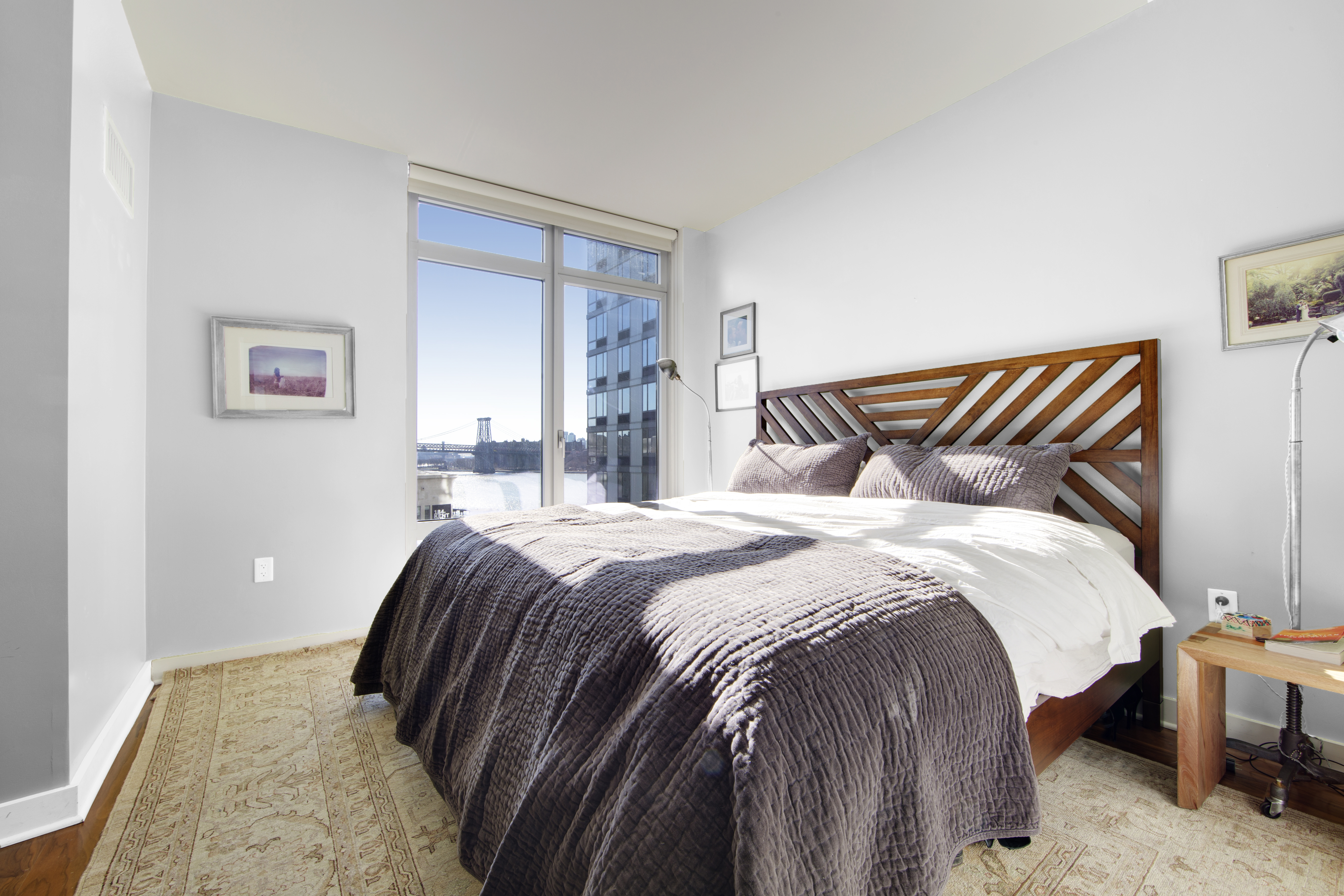 2 Northside Piers, Unit 10B Brooklyn, NY 11249 - Photo 5 of 14 a bedroom with a bed and lamp