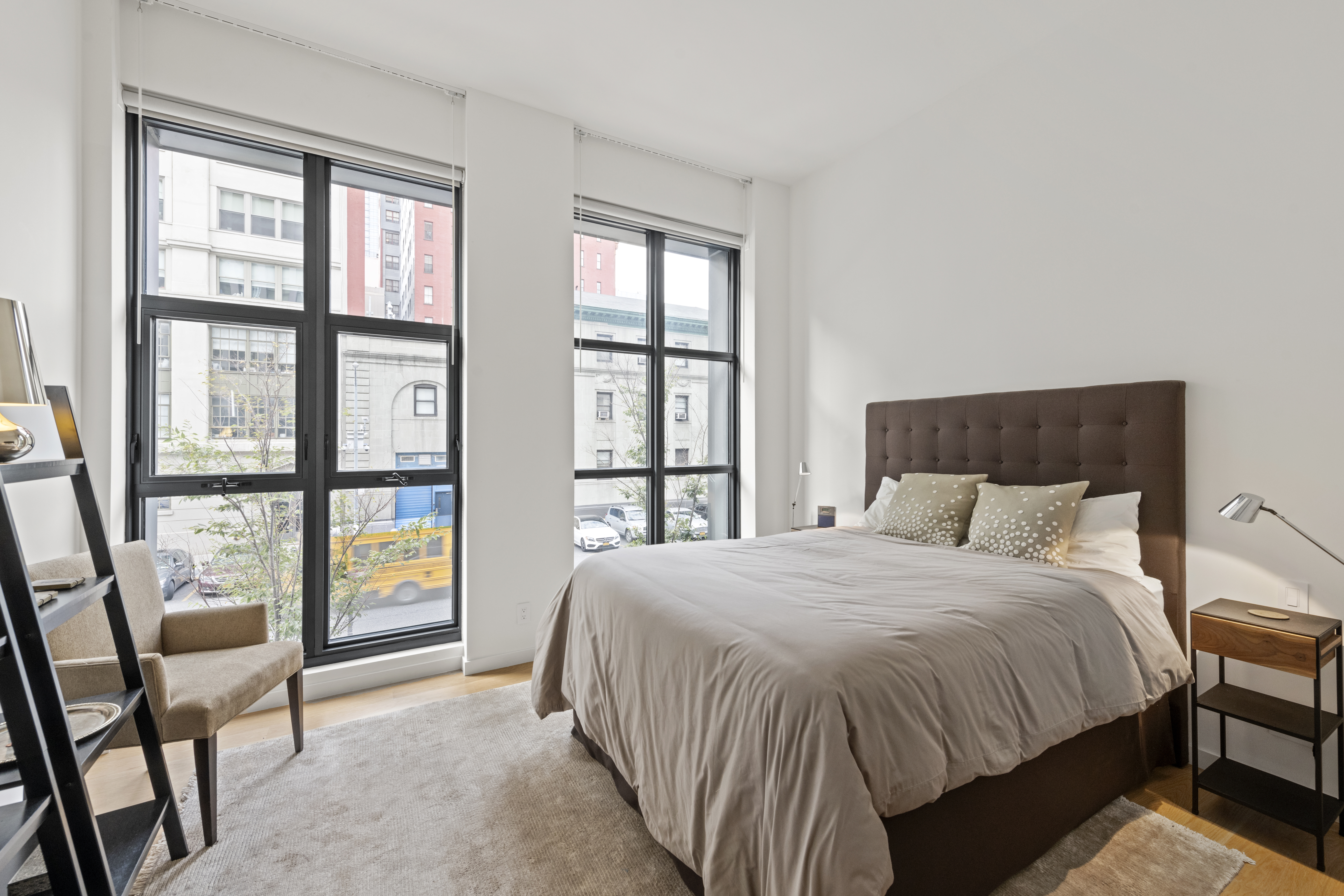 11 North Moore Street, Unit 2B Manhattan, NY 10013 - Photo 7 of 12 a bedroom with a large bed and a large window