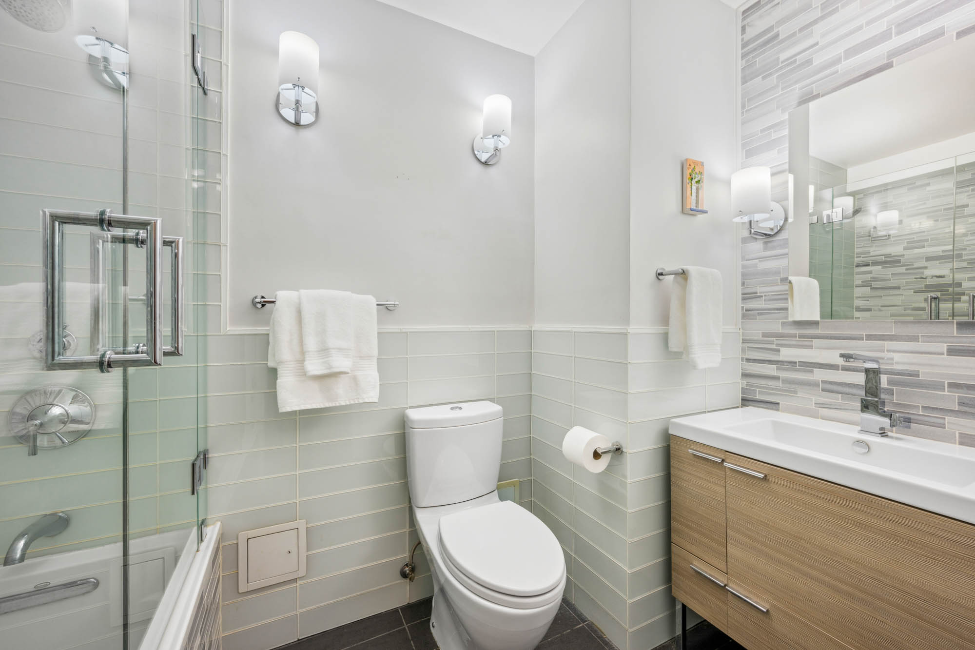 420 East 72nd Street, Unit 2J Manhattan, NY 10021 - Photo 10 of 12 a bathroom with a toilet a sink and shower