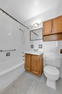 a bathroom with a sink a toilet and bathtub