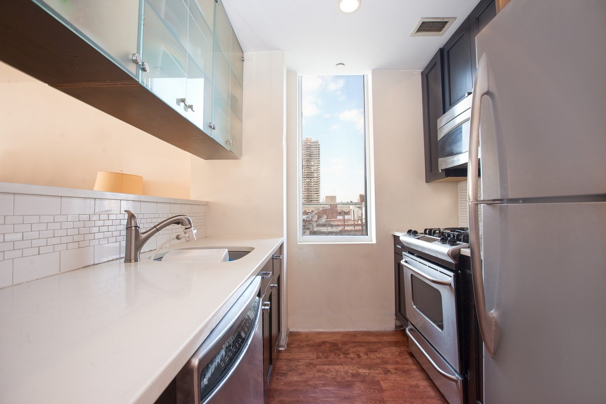 249 East 118th Street, Unit 7A Manhattan, NY 10035 - Photo 5 of 9 a kitchen with a sink stove and refrigerator