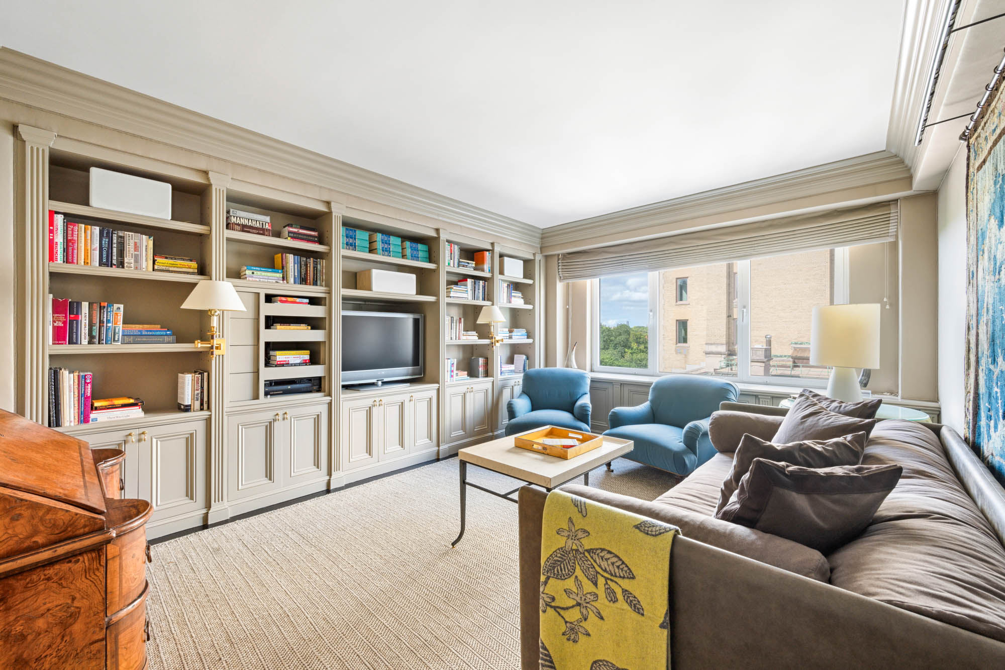 936 5th Avenue, Unit 10AB Manhattan, NY 10021 - Photo 10 of 37 a living room with furniture and a flat screen tv