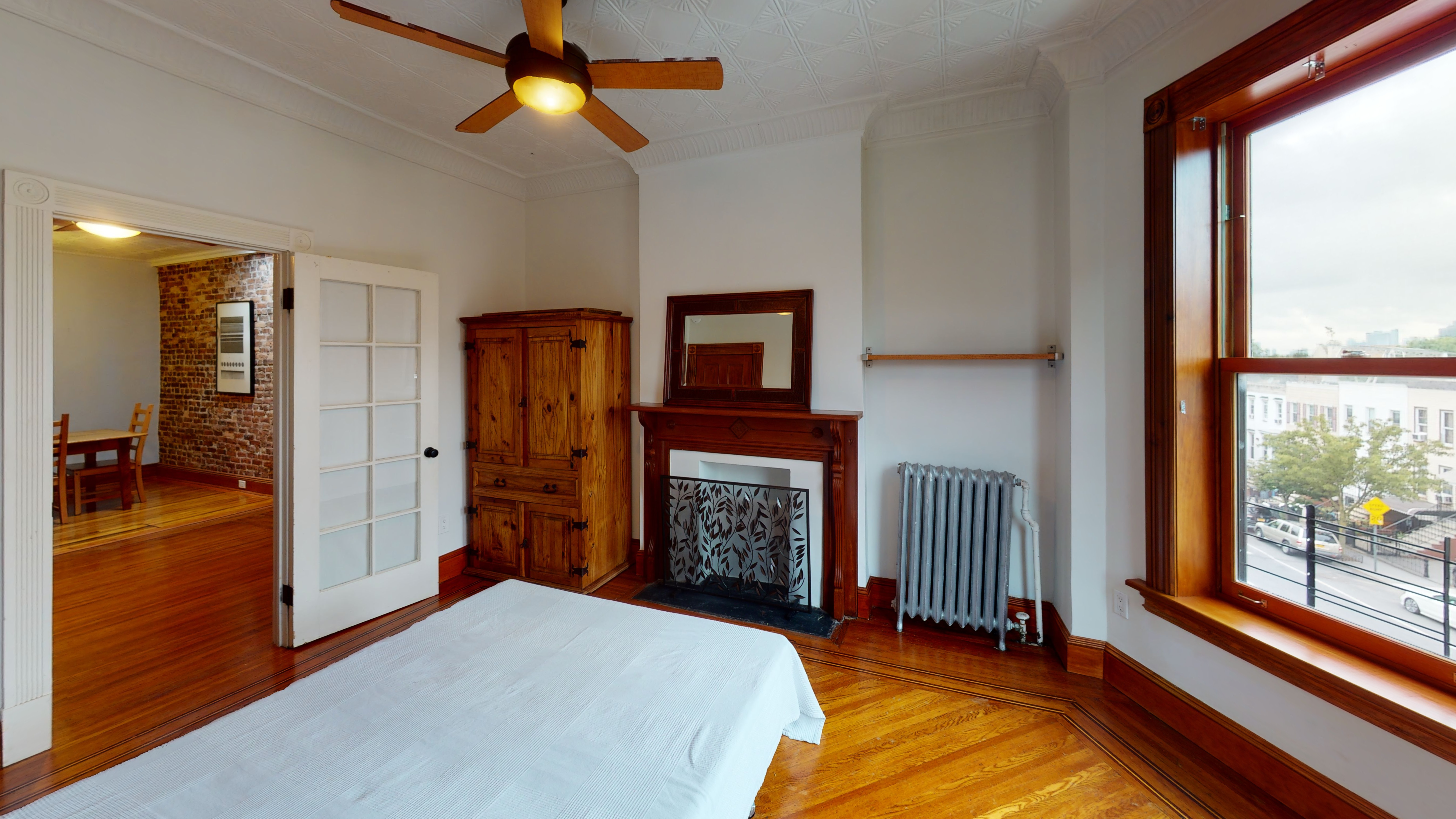 332 15th Street, Unit 3 Brooklyn, NY 11215 - Photo 3 of 8 a bedroom with a bed and a chandelier