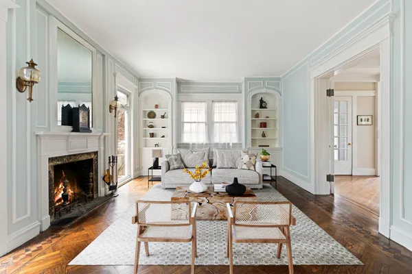 a living room with furniture a fireplace and a table