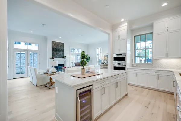 a kitchen with sink and white cabinets