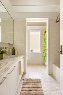 a bathroom with a sink a mirror and a bathtub