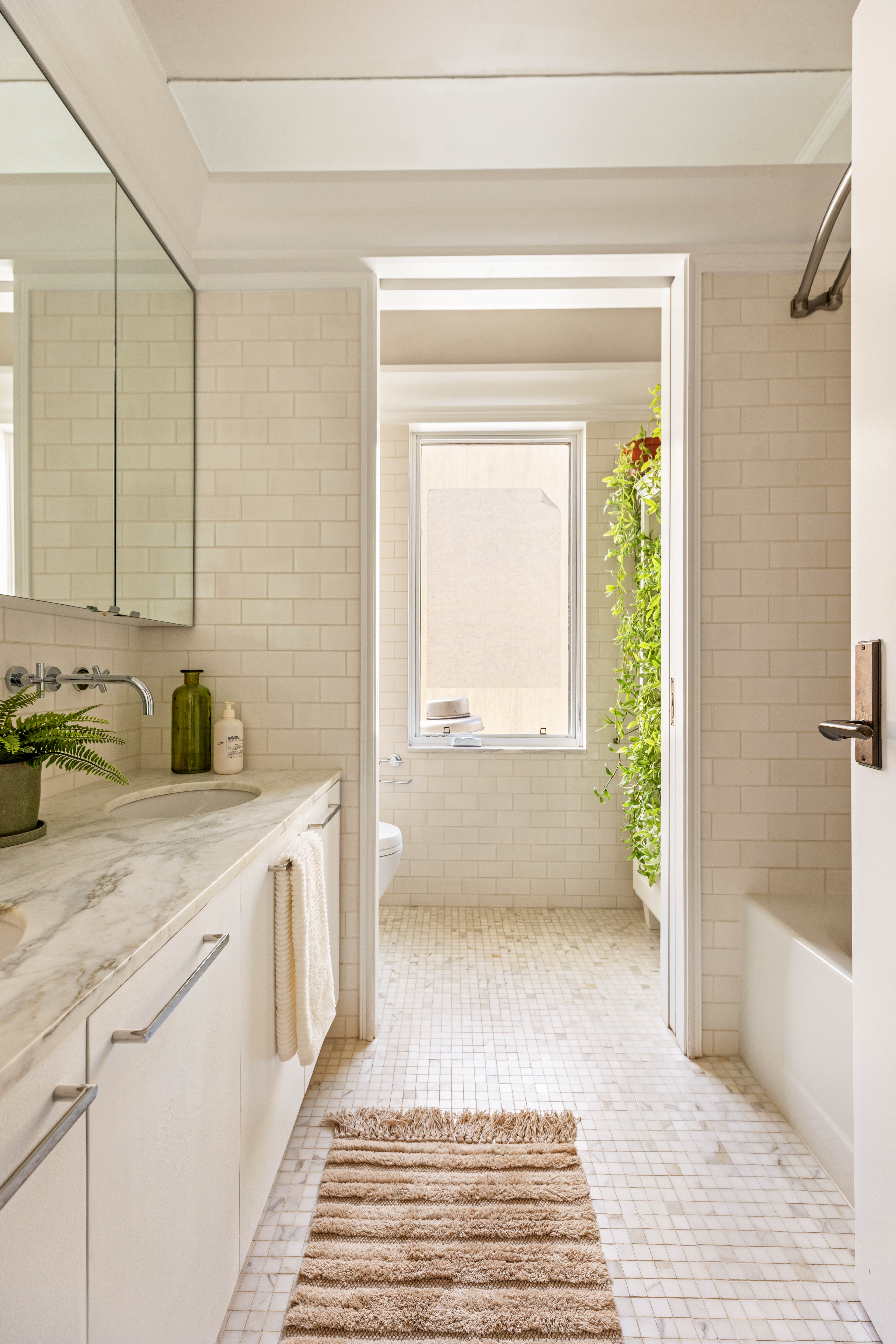 17 Bergen Street, Unit 4/PH Brooklyn, NY 11201 - Photo 11 of 21 a bathroom with a sink a mirror and a bathtub