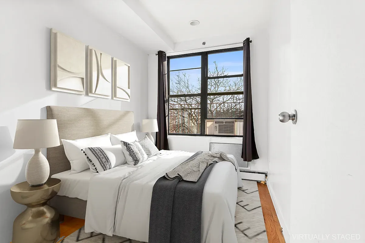 a bedroom with a bed and a large window