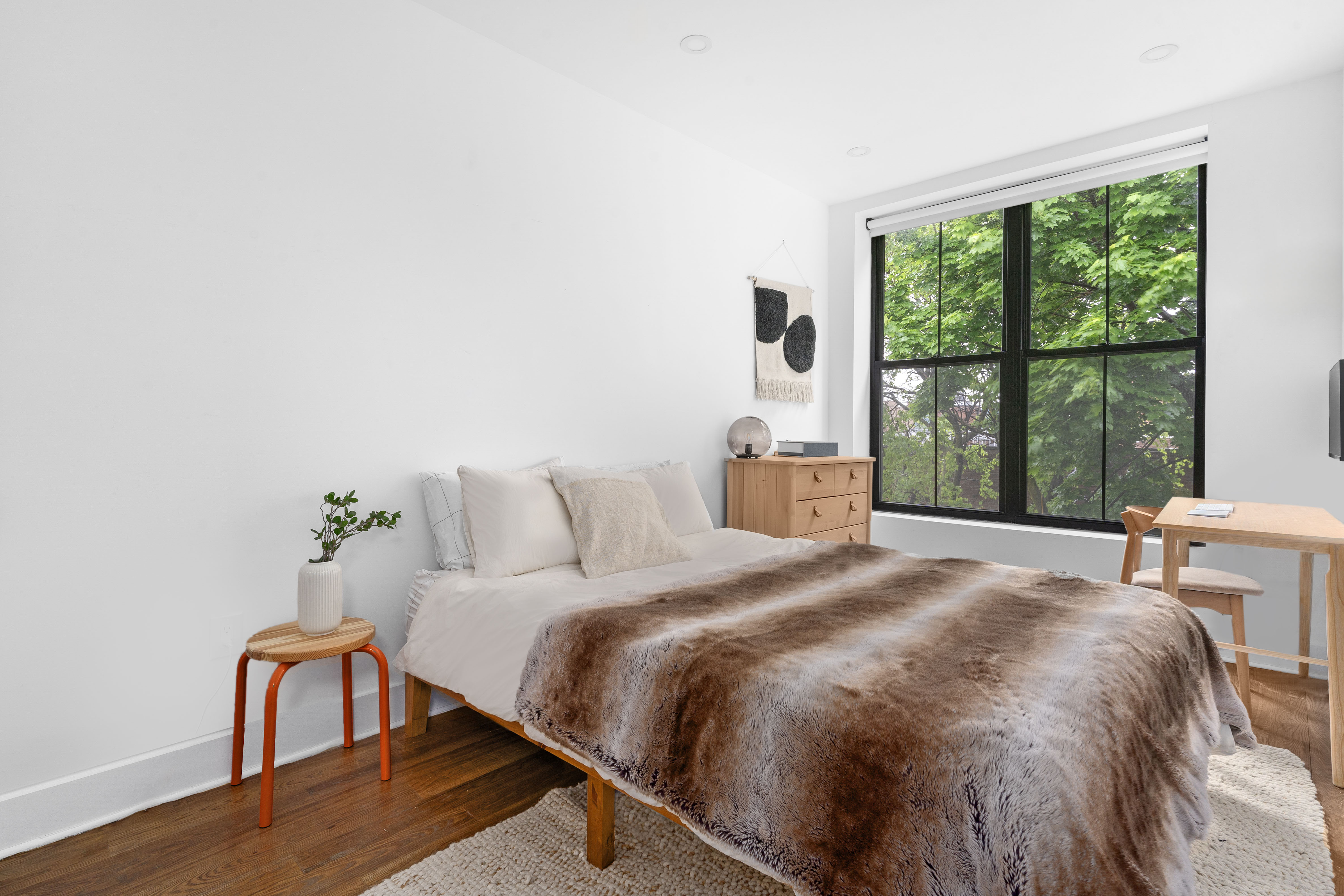 1591 Pacific Street Brooklyn, NY 11213 - Photo 7 of 16 a bedroom with a bed a table and window