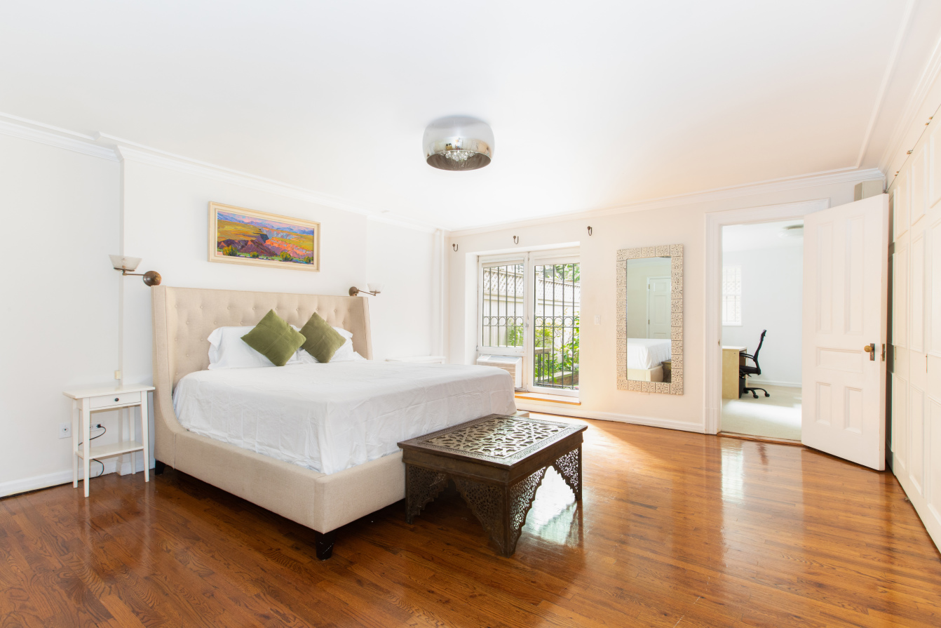 27 West 87th Street, Unit 1 Manhattan, NY 10024 - Photo 7 of 12 a spacious bedroom with a bed and wooden floor