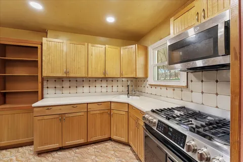 a kitchen with a sink stove and microwave