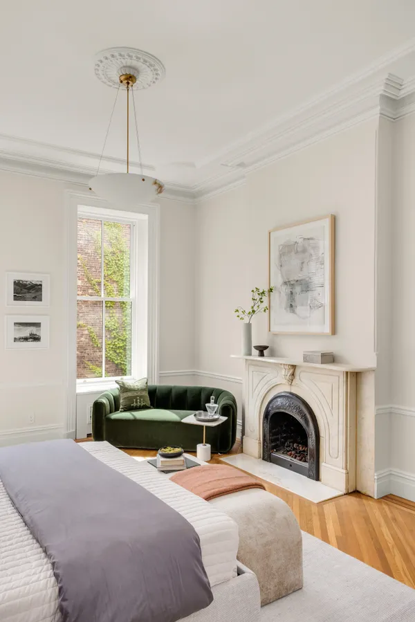 a bedroom with a bed and a fireplace