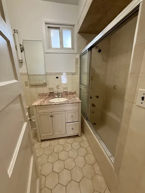 a bathroom with a granite countertop sink a toilet and a mirror