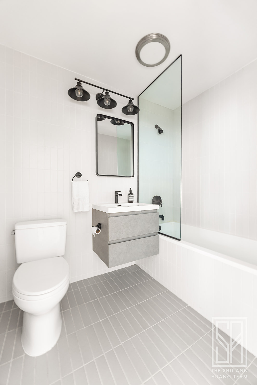 475 Washington Avenue, Unit 4I Brooklyn, NY 11238 - Photo 9 of 10 a bathroom with a white tub sink vanity mirror and toilet