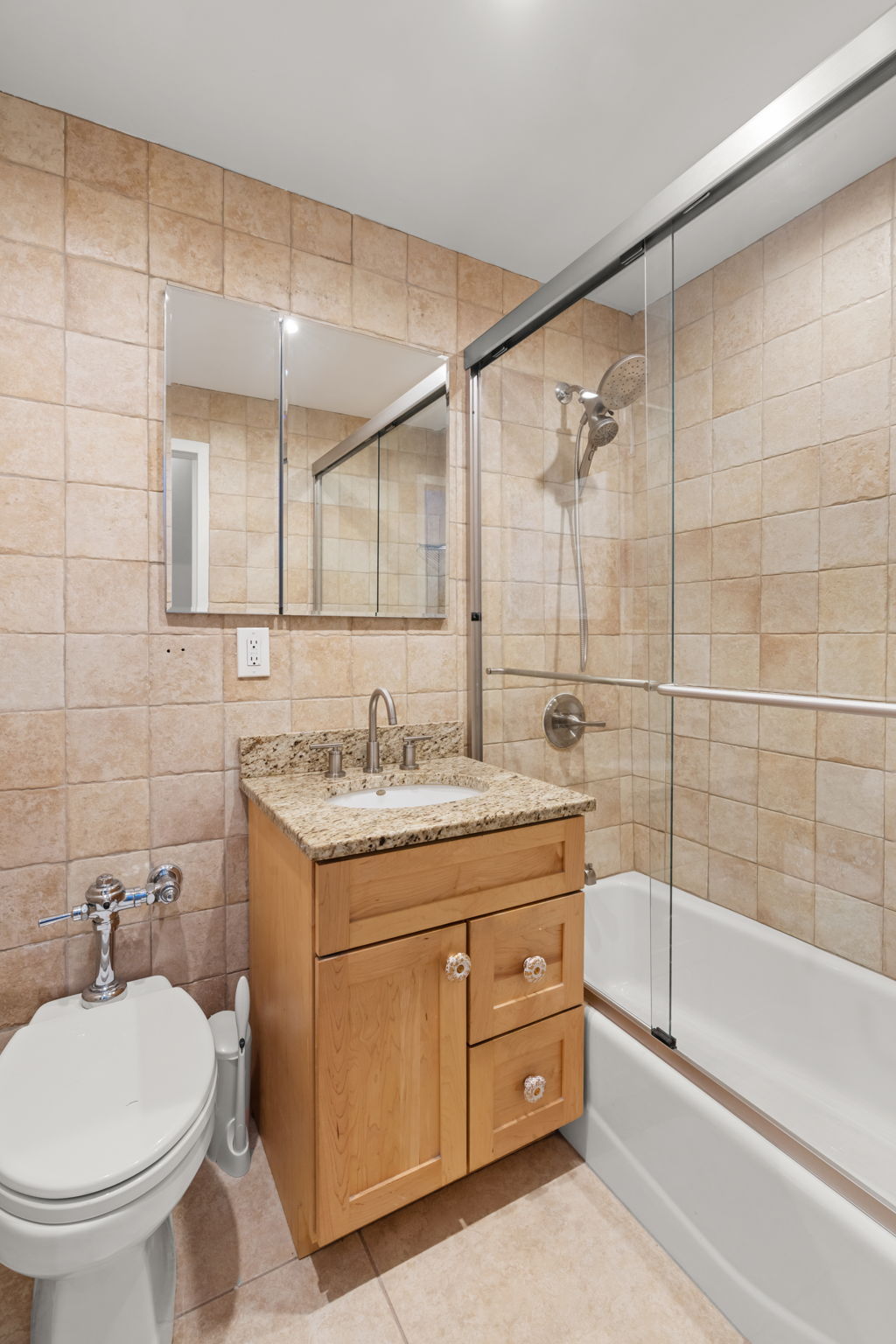 2 Tudor City Place, Unit 6JOS Manhattan, NY 10017 - Photo 16 of 16 a bathroom with a granite countertop sink a toilet and bathtub