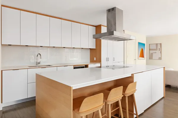 a spacious bathroom with a granite countertop double vanity sink a mirror and a shower