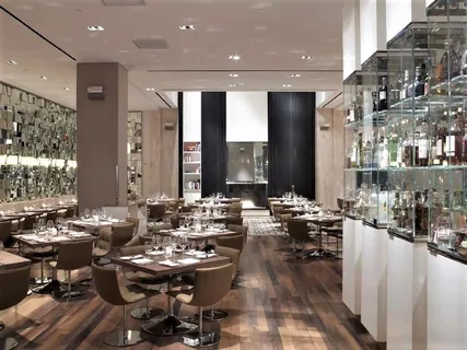 a room with lots of chairs and mirrors