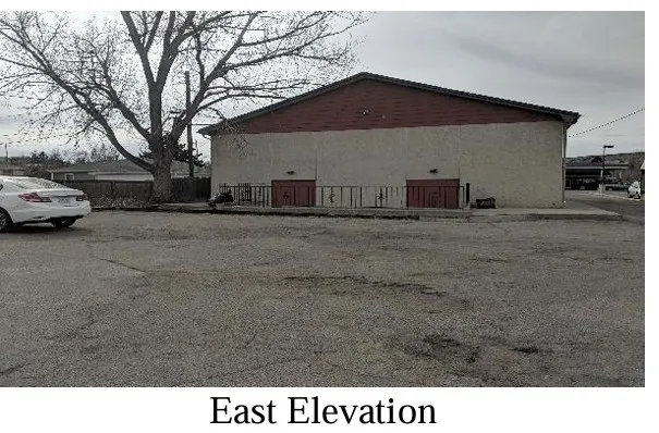 a black and white photo of a house with a yard