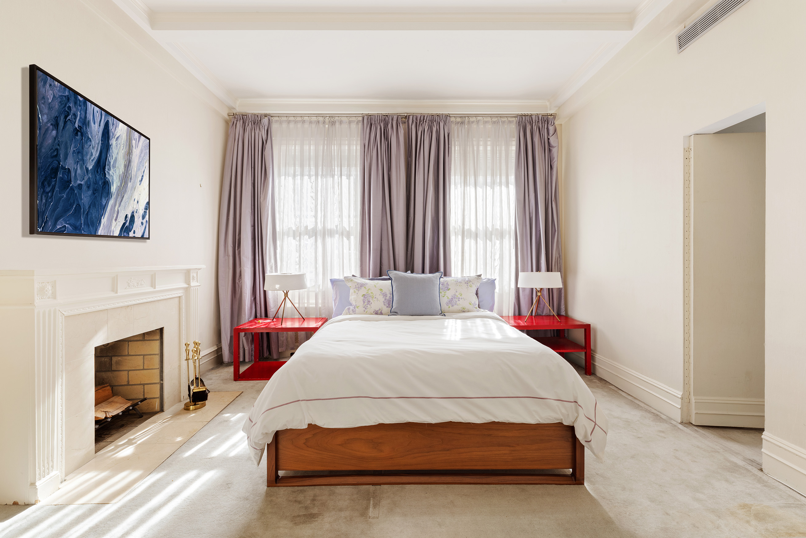 563 Park Avenue, Unit 4E Manhattan, NY 10065 - Photo 9 of 17 a spacious bedroom with a bed and a fireplace