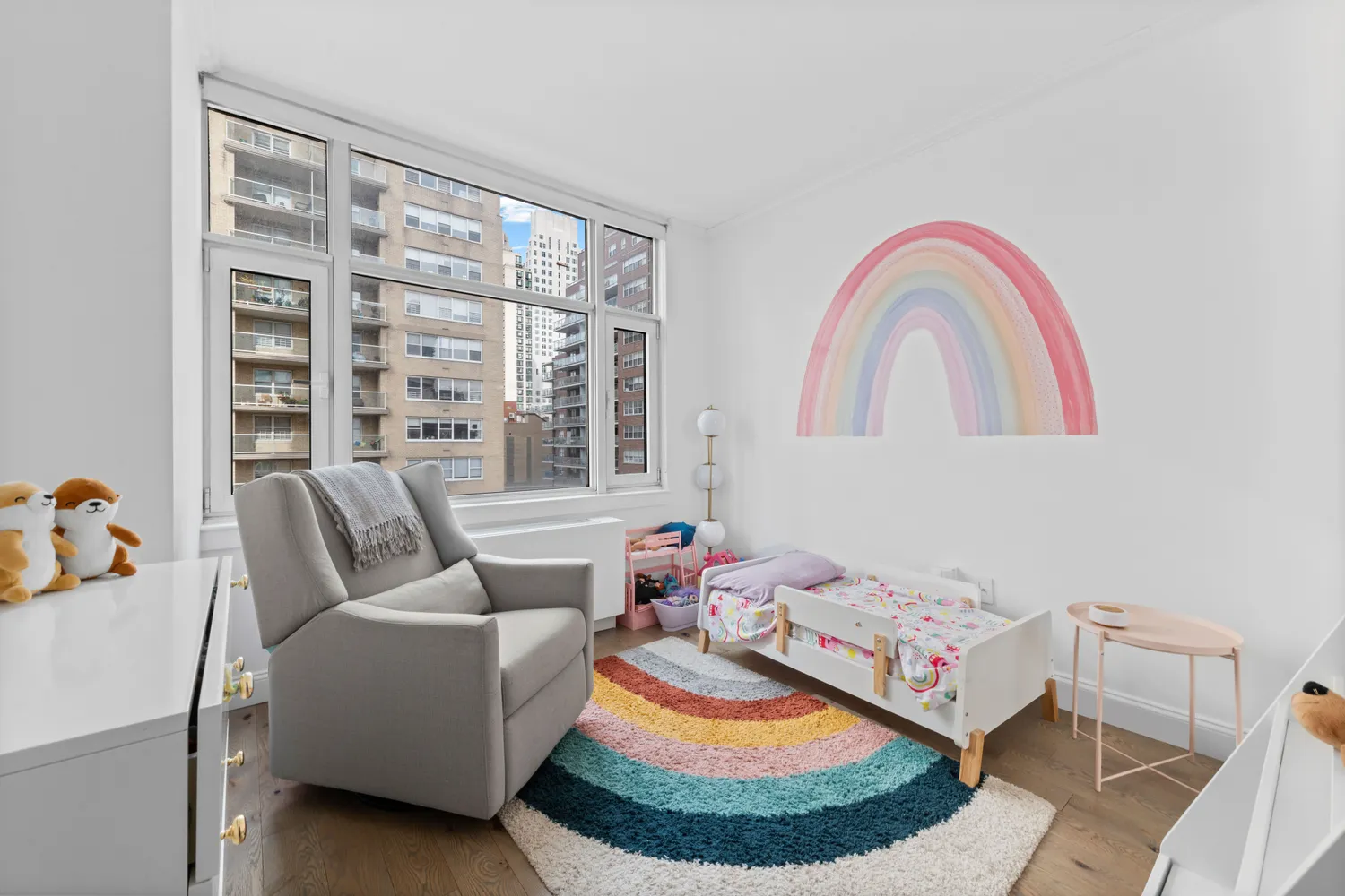 a living room with furniture and a floor to ceiling window