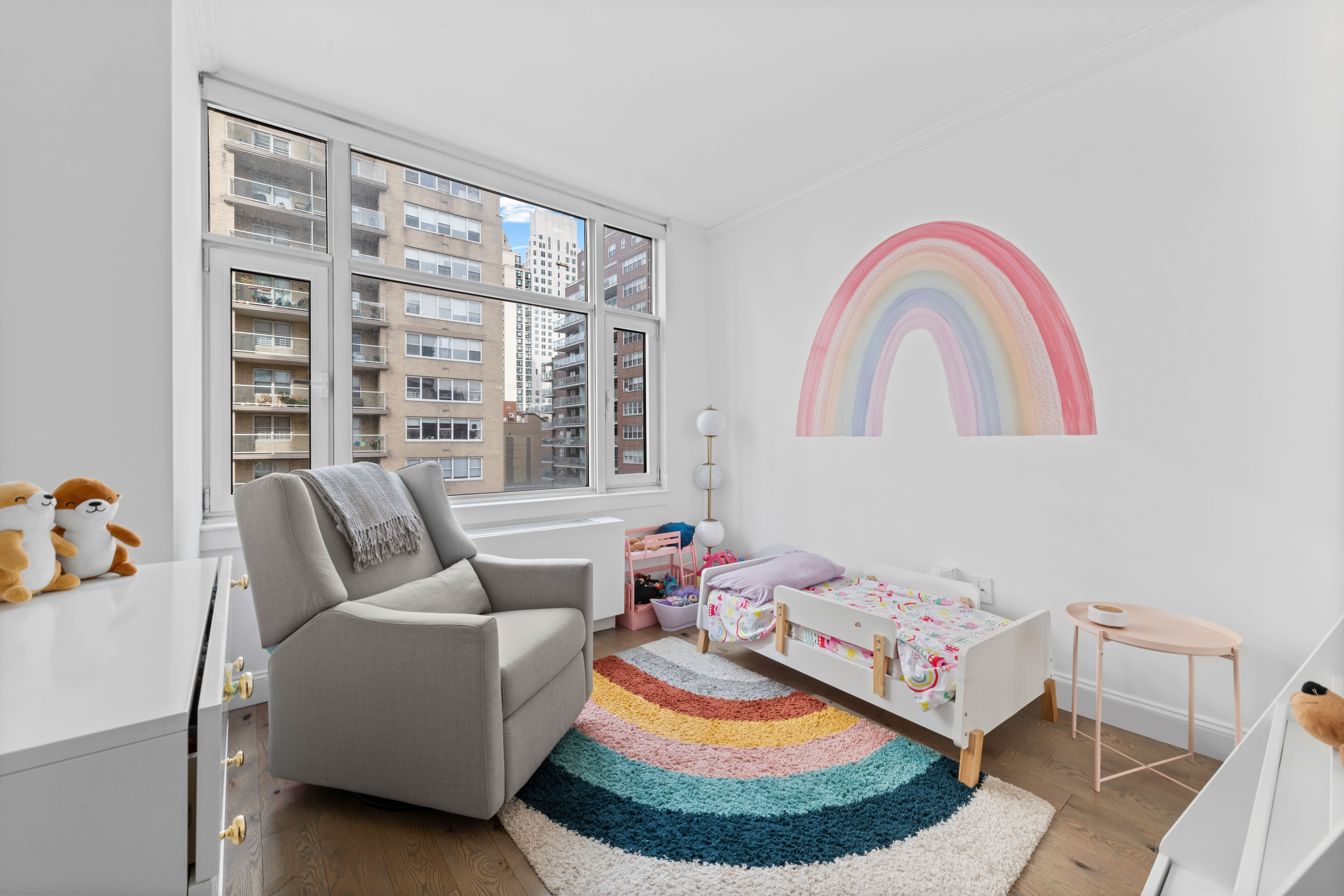 404 East 76th Street, Unit 8A Manhattan, NY 10021 - Photo 8 of 17 a living room with furniture and a floor to ceiling window